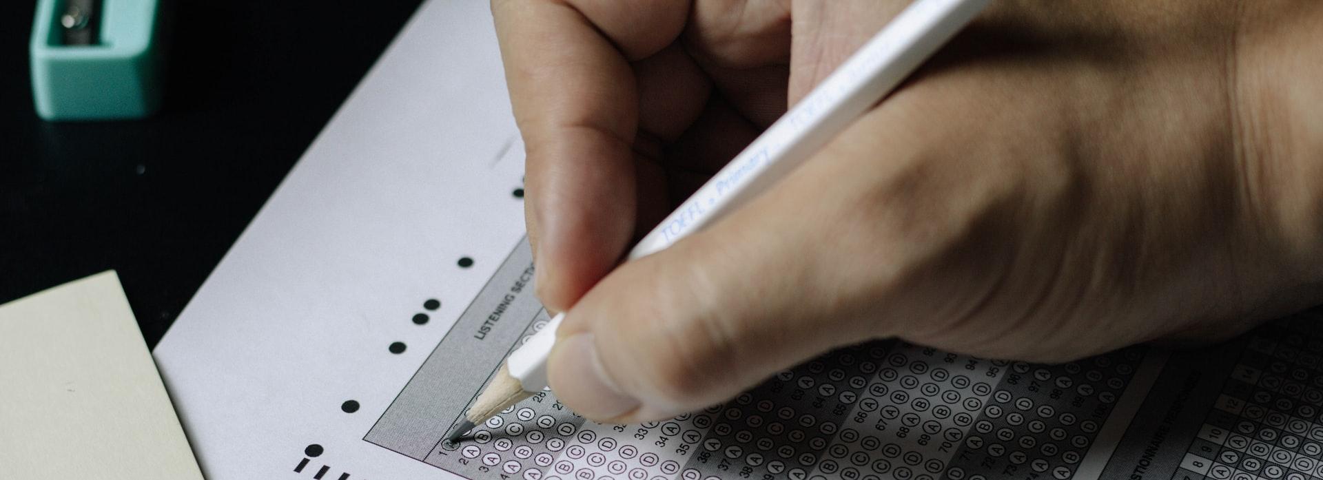 person writing on white paper